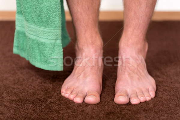 Healthy male feet with towel stepping towards the bathroom. Stock photo © leventegyori