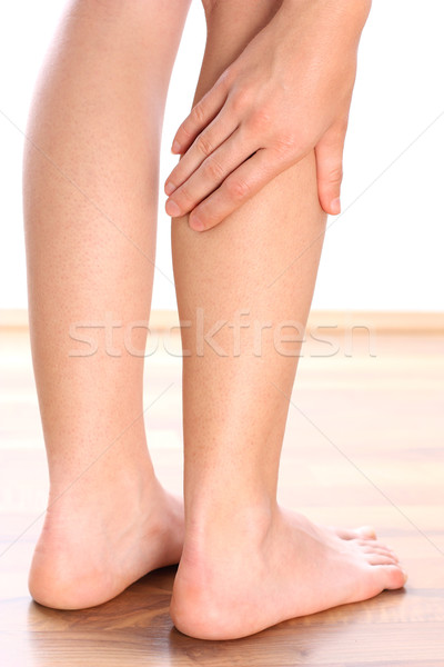 Woman holding leg Stock photo © leventegyori