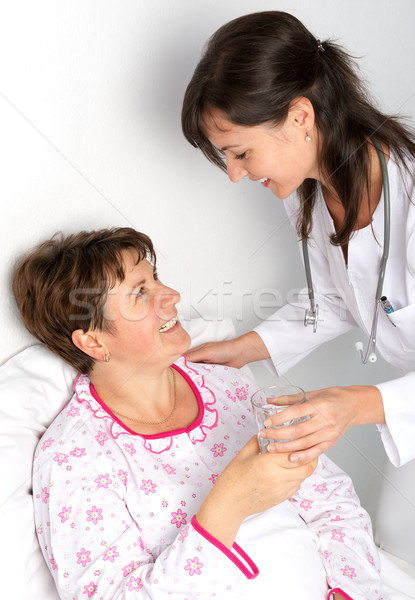 Nurse gives a glass of water Stock photo © leventegyori
