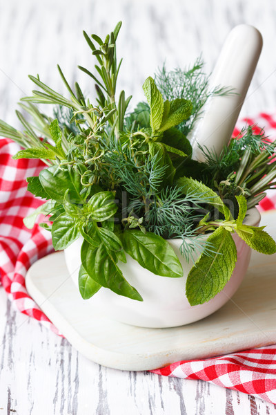 Mortar and herbs. Stock photo © lidante