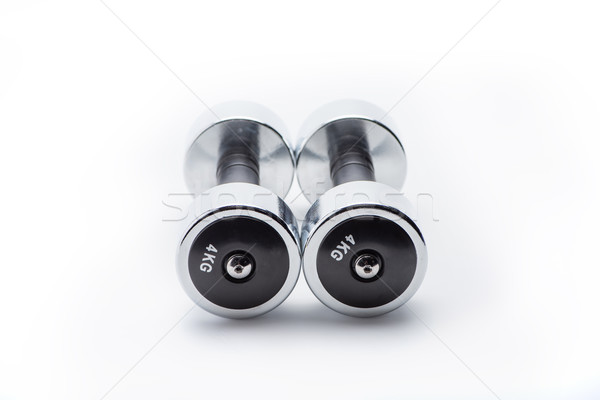 metallic dumbbells isolated on white. equipment sport and healthy living concept Stock photo © LightFieldStudios