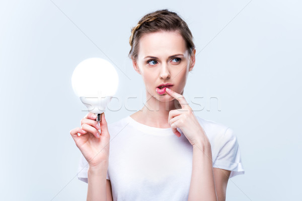 Nachdenklich Frau Glühlampe schönen halten isoliert Stock foto © LightFieldStudios