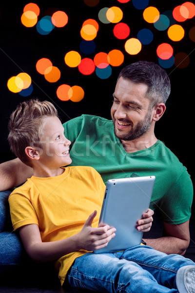 Father and son using digital tablet  Stock photo © LightFieldStudios