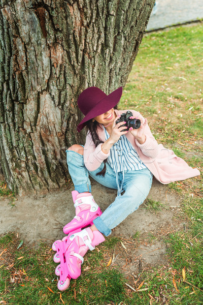 girl in roller skates with camera Stock photo © LightFieldStudios