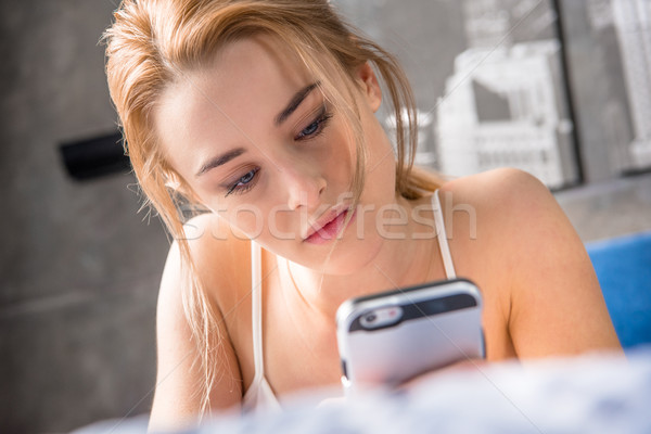 Woman using smartphone Stock photo © LightFieldStudios