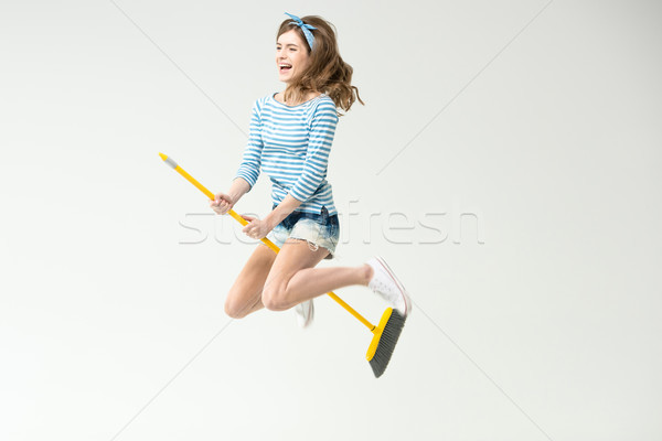 Young woman with broom Stock photo © LightFieldStudios