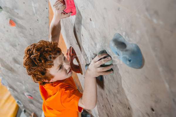 red-headed boy climbing wall Stock photo © LightFieldStudios