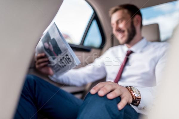 man with newspaper on backseat of car Stock photo © LightFieldStudios