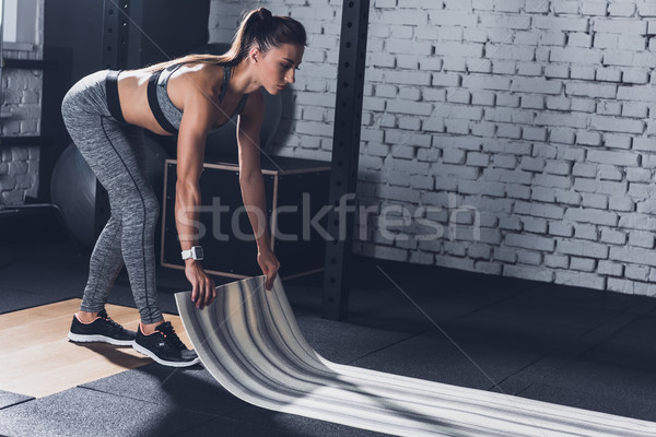 sportive woman with mat Stock photo © LightFieldStudios