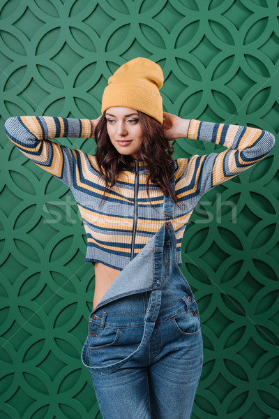 Woman posing in pullover, hat and overalls Stock photo © LightFieldStudios