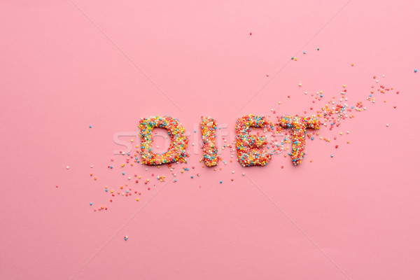 Close-up view of word diet made from sweets isolated on pink, healthy living concept  Stock photo © LightFieldStudios