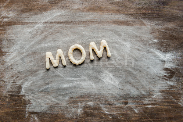 top view of cookies in forms of letters with powdered sugar, cookie dough Stock photo © LightFieldStudios