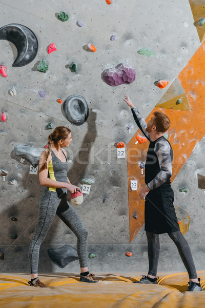 young man pointing to climbing wall Stock photo © LightFieldStudios