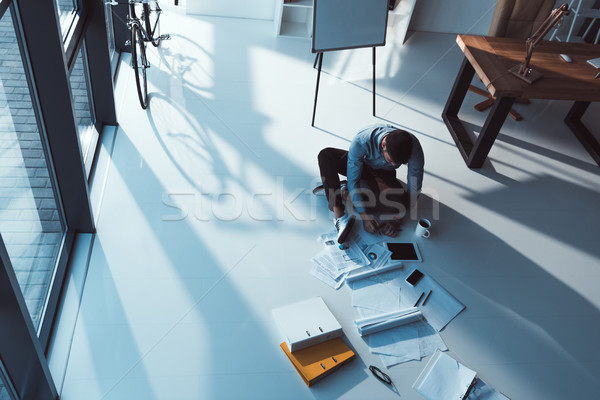 businessman working with papers and devices Stock photo © LightFieldStudios