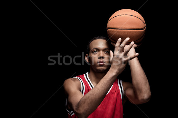 Young athletic man in uniform playing basketball with ball on black   Stock photo © LightFieldStudios