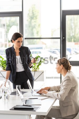 Seductive secretery leaning over desk Stock photo © LightFieldStudios