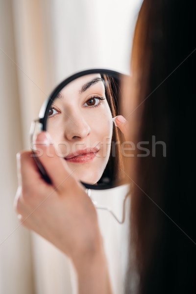 Nő jelentkezik arckrém gyönyörű nő néz tükör Stock fotó © LightFieldStudios
