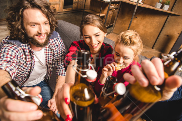 Amis bière bouteilles souriant séance [[stock_photo]] © LightFieldStudios