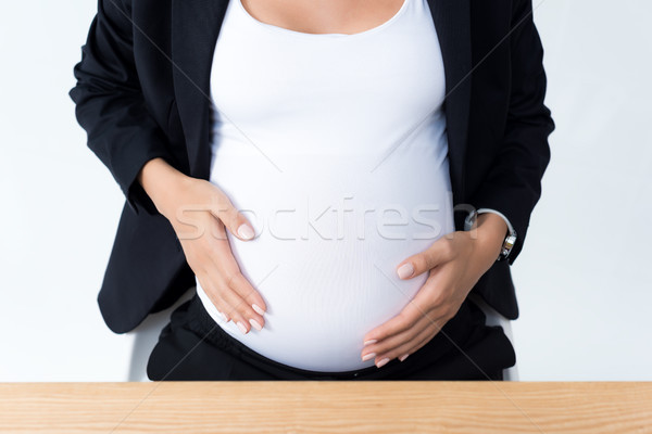 pregnant businesswoman touching her tummy Stock photo © LightFieldStudios