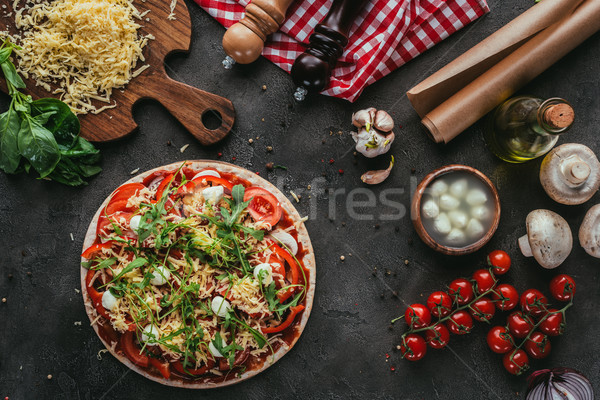 top view of unprepared pizza with ingredients on concrete table Stock photo © LightFieldStudios