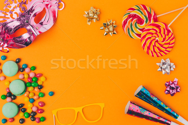 flat lay with candies and and party objects isolated on orange, purim holiday concept Stock photo © LightFieldStudios