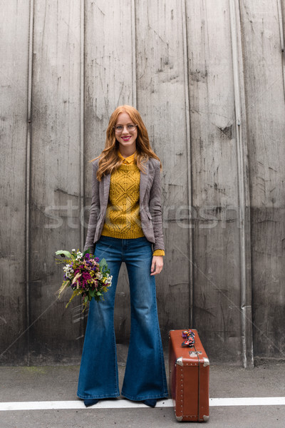 smiling girl with flowers and suitcase Stock photo © LightFieldStudios