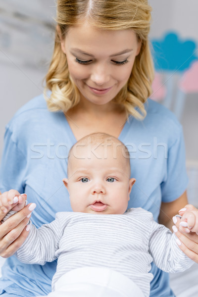 mother holding babys hands Stock photo © LightFieldStudios