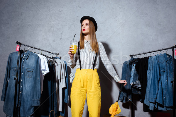 girl in boutique with clothes around Stock photo © LightFieldStudios