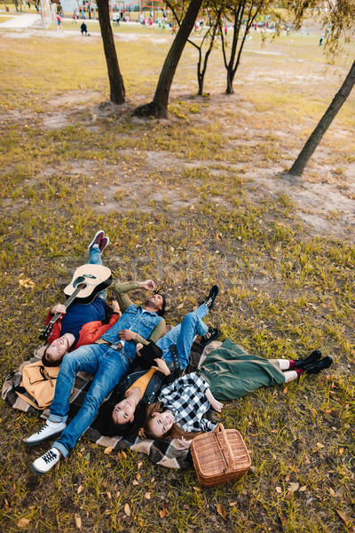 Stock photo: multicultural friends resting on blanket together