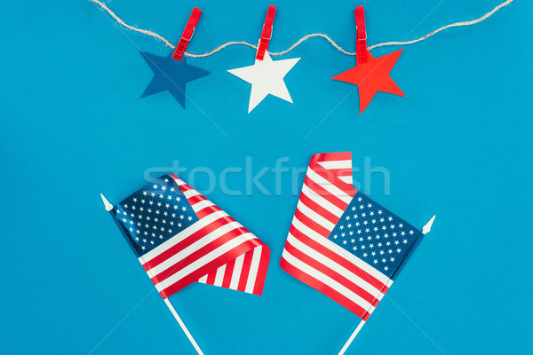 top view of arranged stars and american flags isolated on blue, presidents day celebration concept Stock photo © LightFieldStudios