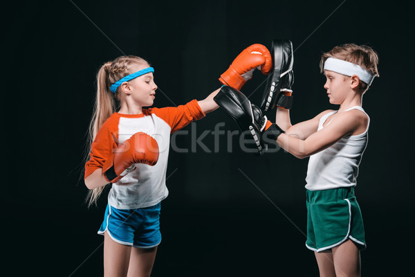 side view of kids pretending boxing isolated on black, active kids concept Stock photo © LightFieldStudios