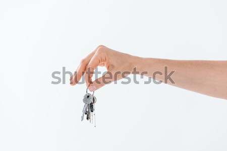 partial view of hand holding keys from new house on white Stock photo © LightFieldStudios