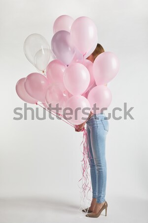 woman holding balloons Stock photo © LightFieldStudios