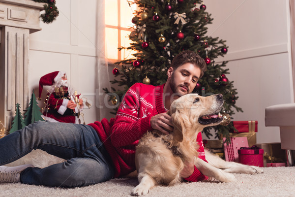 man playing with dog at christmastime Stock photo © LightFieldStudios