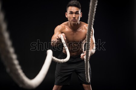 Uomo combattimento corde esercizio muscolare a torso nudo Foto d'archivio © LightFieldStudios