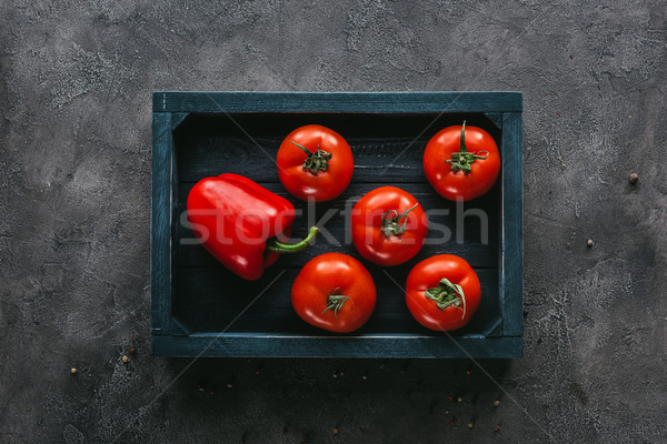 Stock photo: top view of tomatoes and bell pepper in box on concrete surface