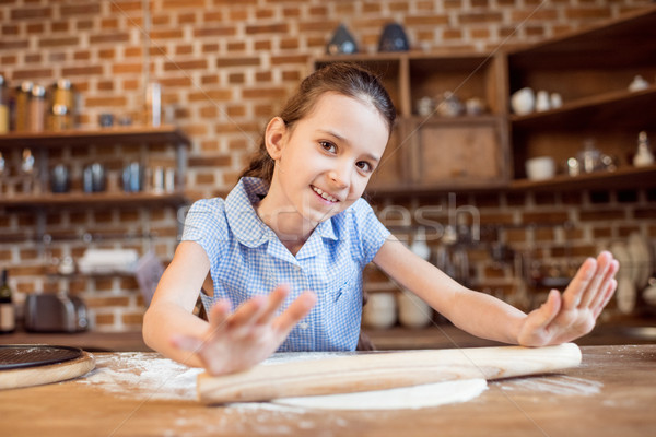 little girl making pizza dough on wooden tabletop in kitchen  Stock photo © LightFieldStudios