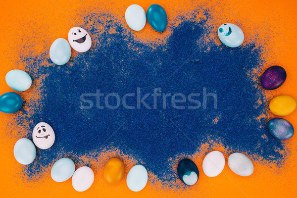 top view of blue sand and easter eggs on orange surface Stock photo © LightFieldStudios