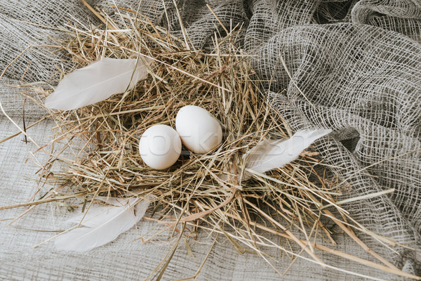 white eggs laying on straw over sackcloth Stock photo © LightFieldStudios