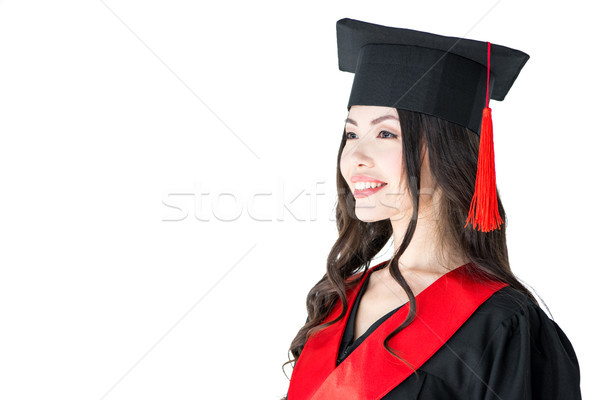 Beautiful young brunette woman in academic gown and mortarboard smiling Stock photo © LightFieldStudios