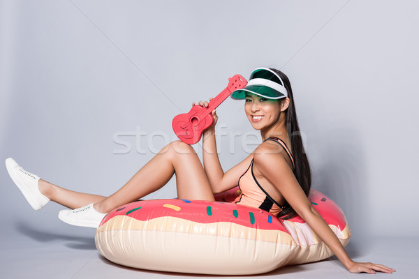 woman on pool float with ukulele Stock photo © LightFieldStudios