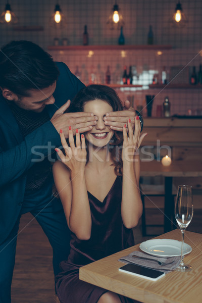 Férfi meglepő nő izgatott asztal szemek Stock fotó © LightFieldStudios