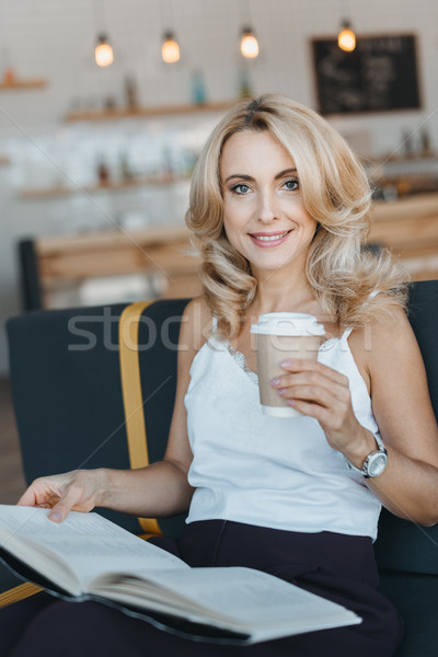 woman reading book in cafe Stock photo © LightFieldStudios