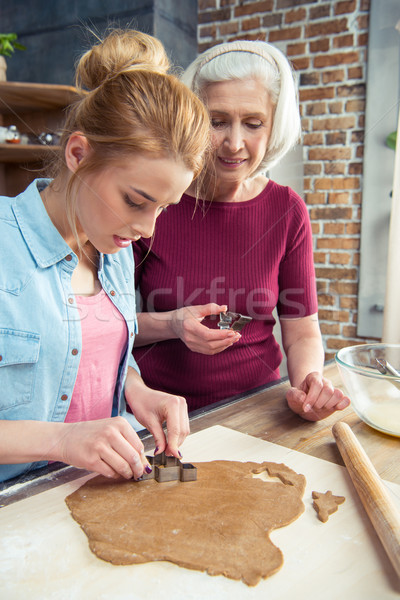 Grandmother and granddaughter making cookies Stock photo © LightFieldStudios