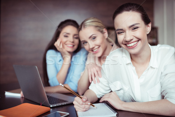 Stock photo: portrait of cheerful businesswomen working on new business idea