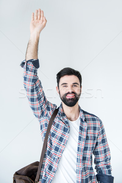 portrait of young bearded man with raising hand in studio on white  Stock photo © LightFieldStudios