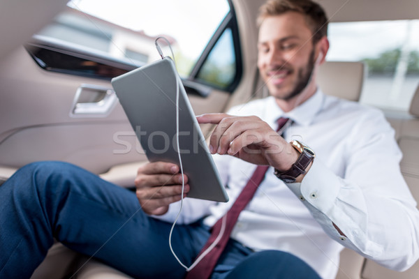man with digital tablet in car Stock photo © LightFieldStudios