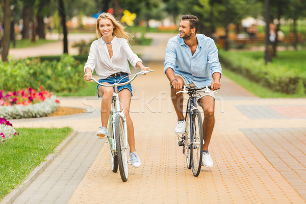 happy couple riding bicycles Stock photo © LightFieldStudios