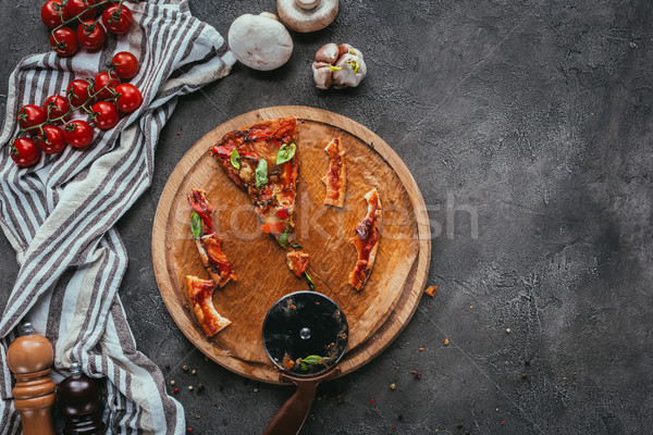 top view of pieces of eaten pizza with cutter on concrete table Stock photo © LightFieldStudios