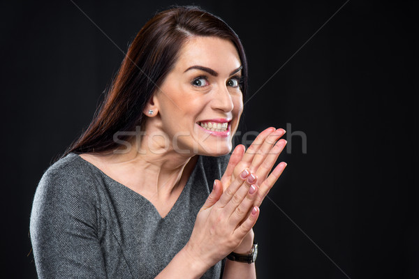 Scheming woman rubbing her hands  Stock photo © LightFieldStudios